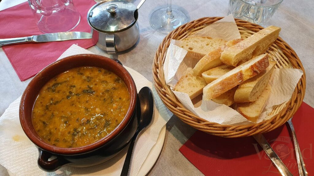 The Best Traditional Dishes You Can Only Try While Traveling 2 Traditional Dishes. Enjoying a warm bowl of Ribollita on a chilly Tuscan evening.