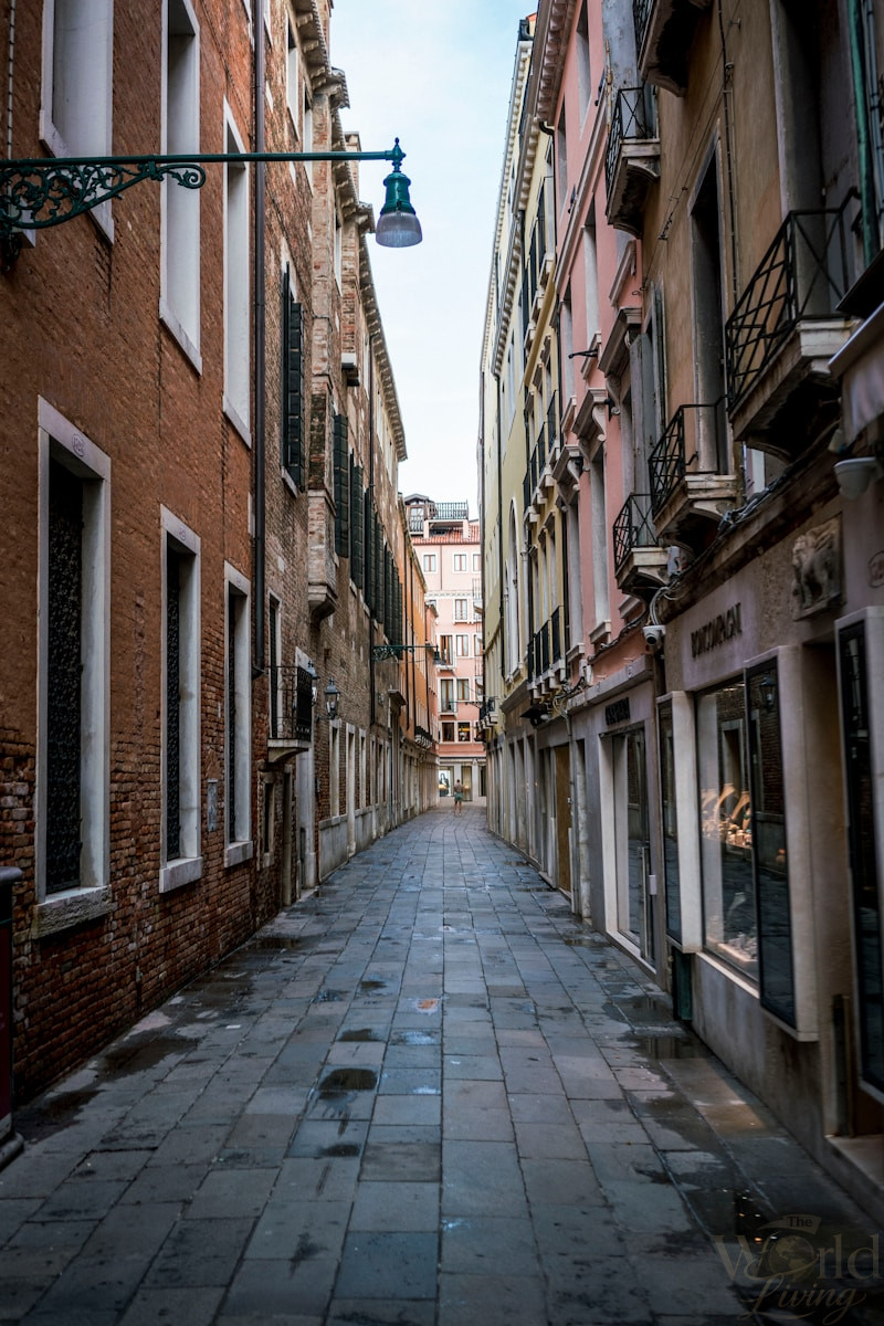 The Magic of Getting Lost While Traveling 3 Getting Lost While Traveling. a narrow street with a lamp post in the middle of it.
